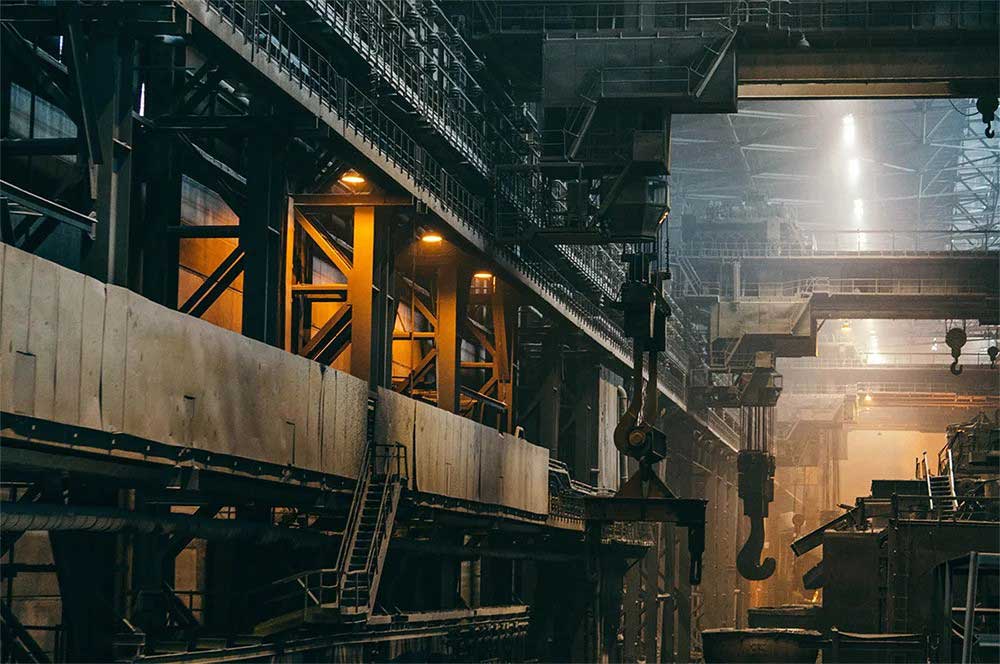 Industrial marine engine workshop with heavy-duty steel structures and overhead cranes.